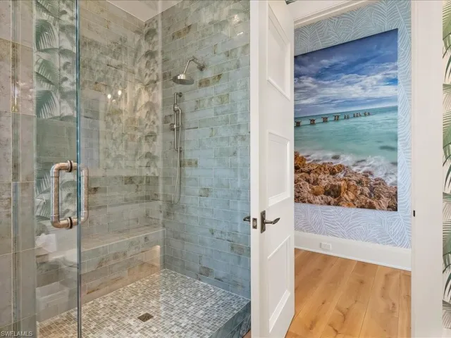 Full bath featuring a stall shower and wood finished floors
