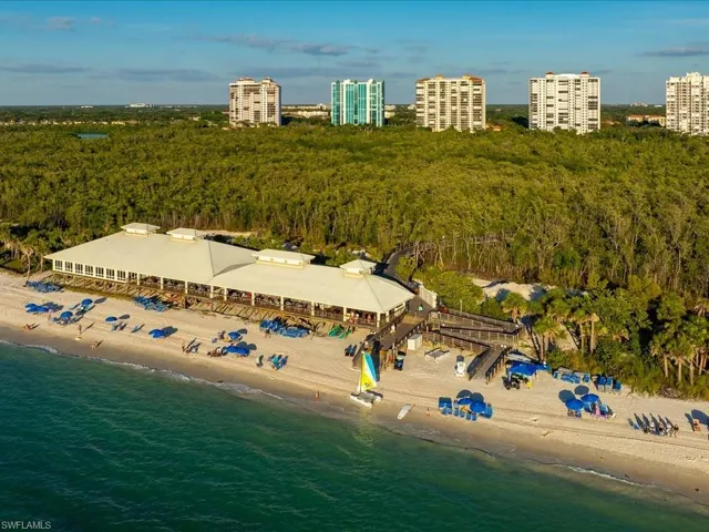 Drone / aerial view of a heavily wooded area and expansive beach