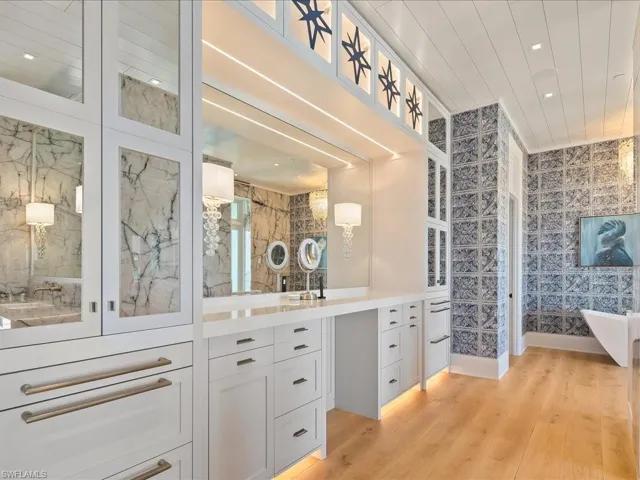 Full bath with vanity, recessed lighting, light wood-style floors, and a soaking tub