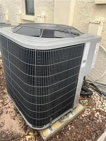 Exterior view of a central air condition unit and stucco siding