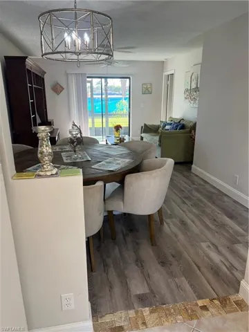 Dining space featuring wood finished floors and a chandelier
