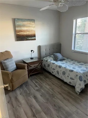Bedroom featuring wood finished floors and ceiling fan