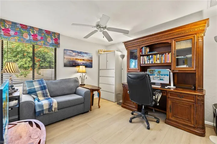 Office featuring visible vents, light wood-style flooring, and a ceiling fan