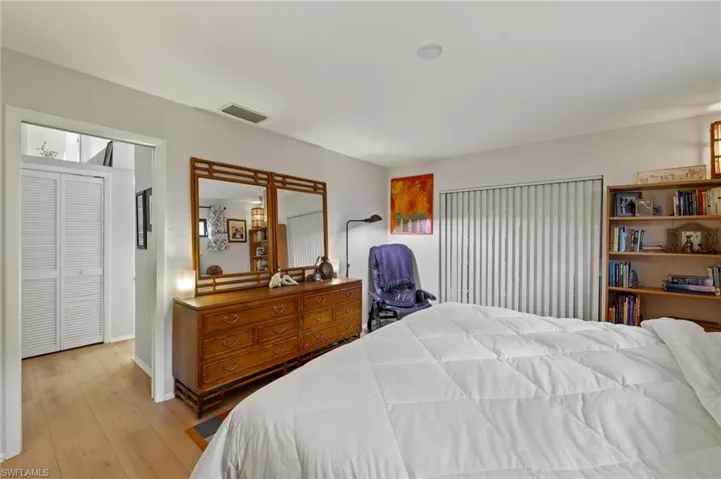 Bedroom featuring light wood-type flooring and visible vents