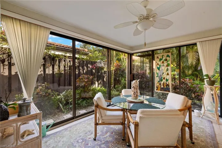 Sunroom / solarium featuring ceiling fan