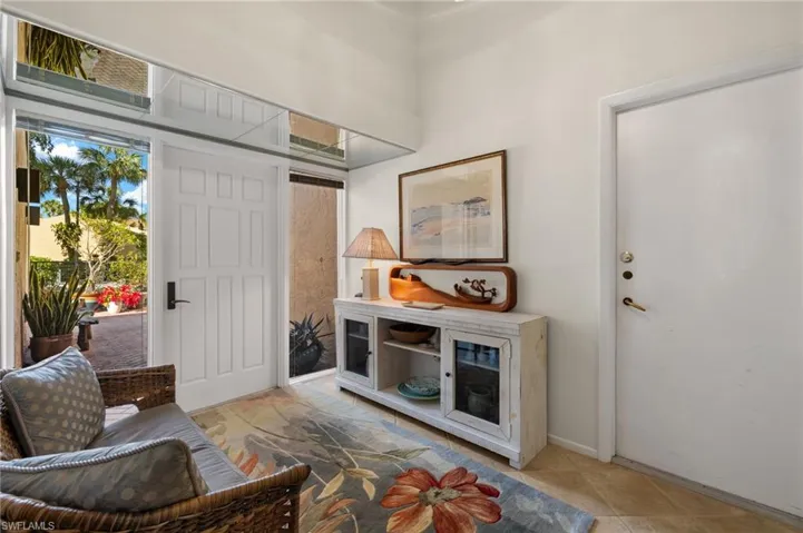 Foyer entrance featuring light tile patterned flooring