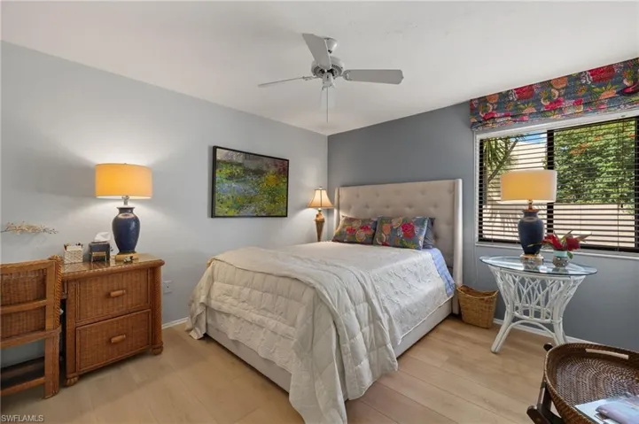 Bedroom featuring light wood-type flooring, ceiling fan, and baseboards