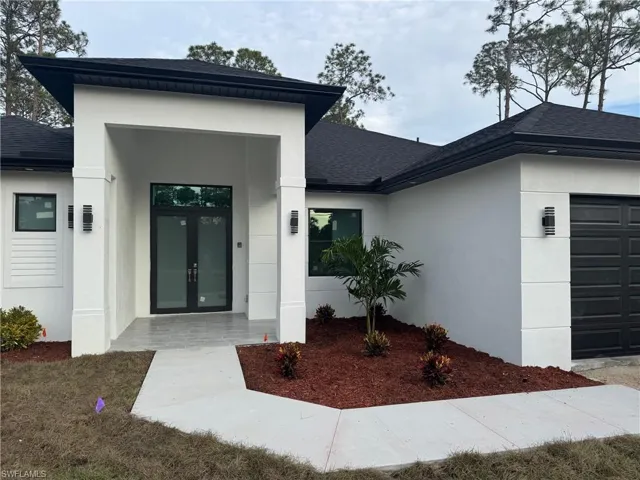 Property entrance featuring french doors and a garage