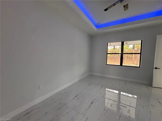 Unfurnished room with a tray ceiling