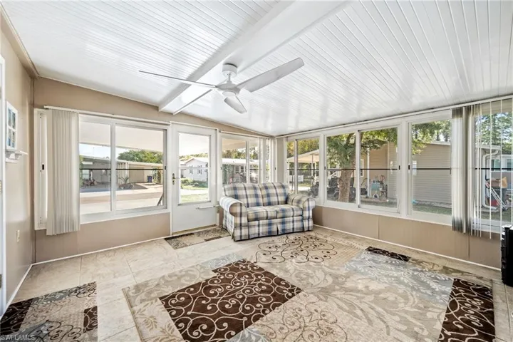 Sunroom / solarium featuring a ceiling fan and plenty of natural light