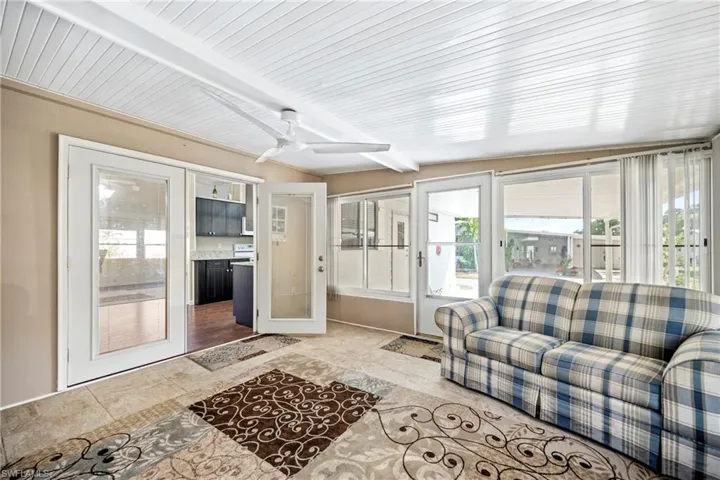 Sunroom / solarium featuring beamed ceiling and french doors
