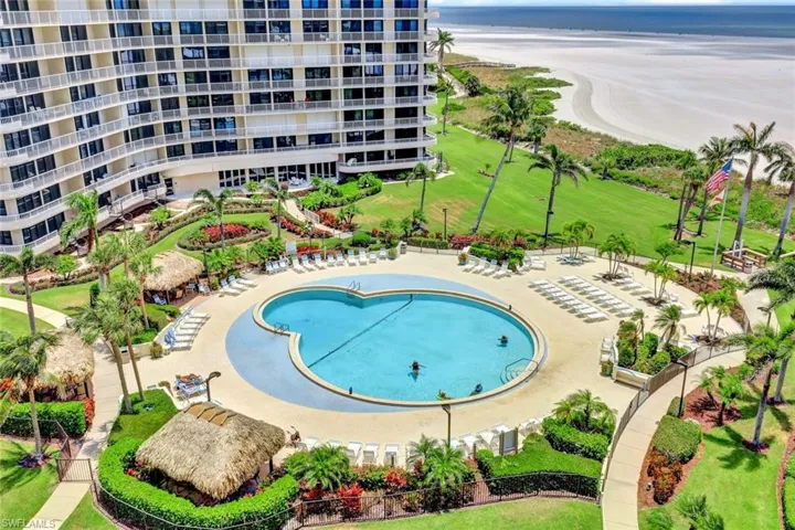 View of pool featuring a water view and a lawn