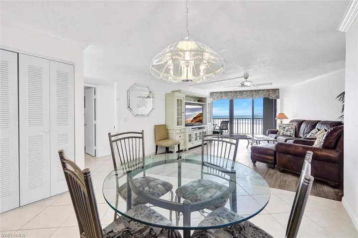 Dining area featuring crown molding, light tile patterned flooring, and ceiling fan