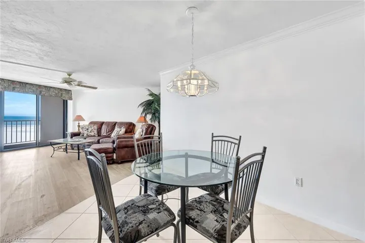 Dining space with ceiling fan and light tile patterned floors