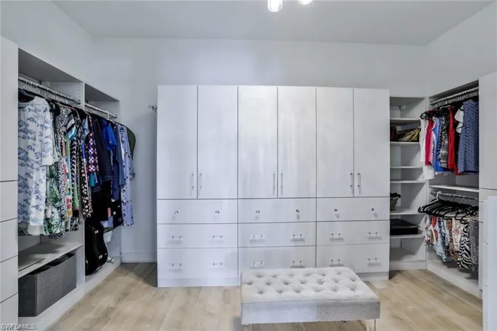 Spacious closet with light hardwood / wood-style floors