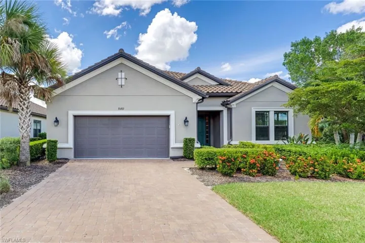 View of front of house featuring a garage and a front yard
