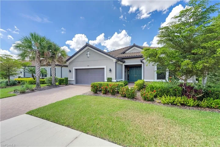 View of front of house featuring a garage and a front lawn