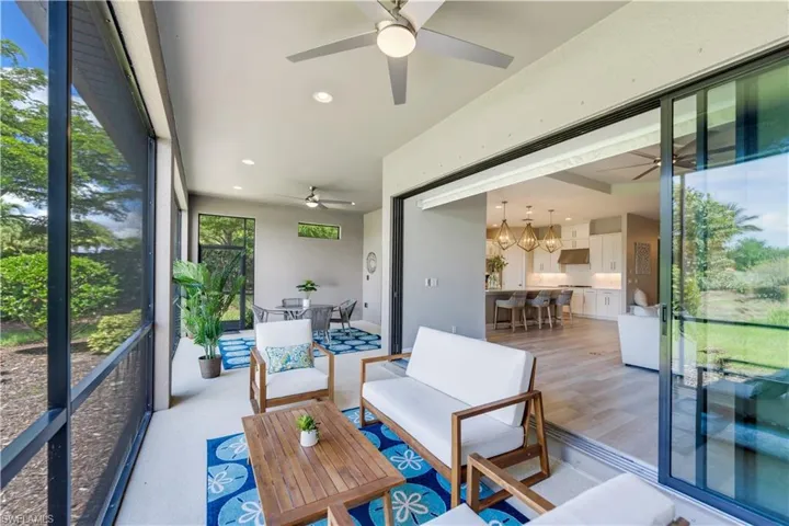 Sunroom / solarium with ceiling fan with notable chandelier