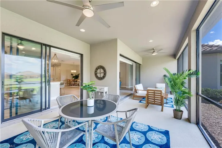 Sunroom / solarium featuring ceiling fan