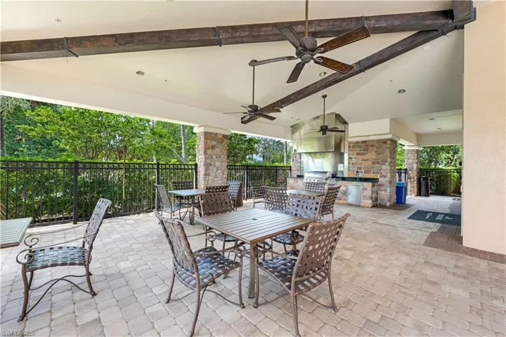 View of patio featuring ceiling fan and area for grilling