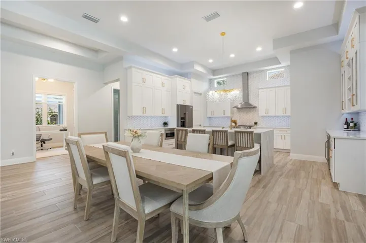 Dining area featuring light wood-style floors and recessed lighting