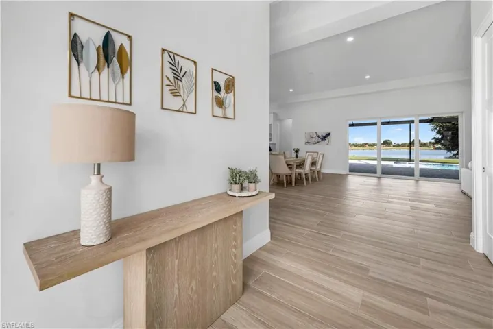 Hall featuring recessed lighting, wood tiled floors, and a water view