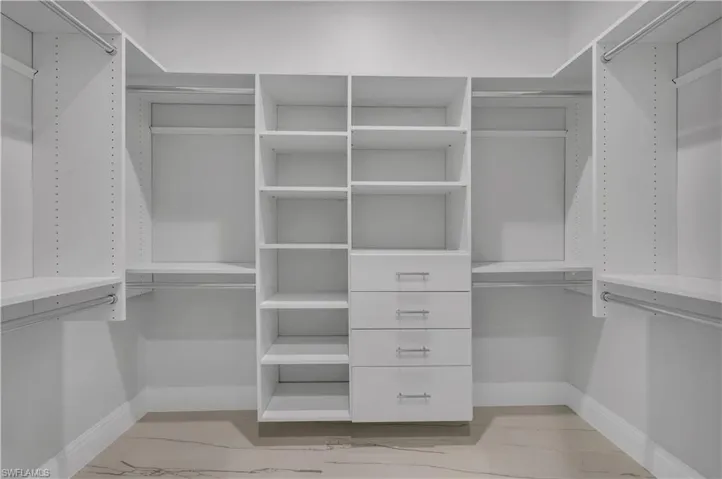 Spacious closet with light marble finish flooring