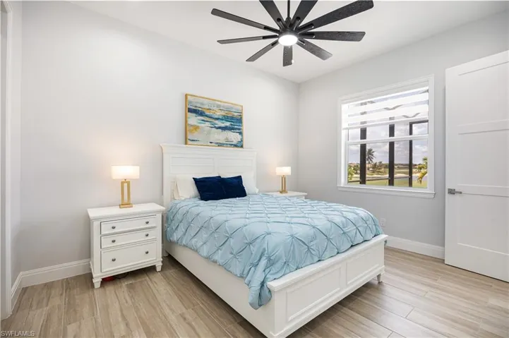 Bedroom with light wood-style flooring and ceiling fan
