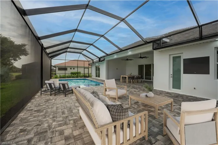 View of patio with a sunroom, an outdoor hangout area, an outdoor pool, a ceiling fan, and a lanai