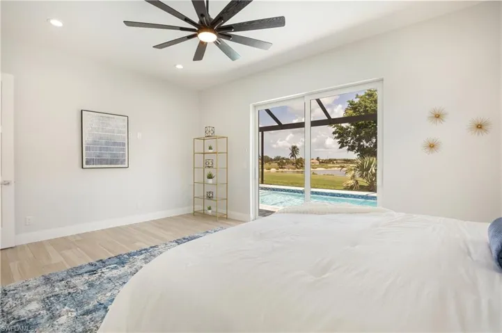 Bedroom with recessed lighting, light wood-style floors, access to outside, a ceiling fan, and a sunroom