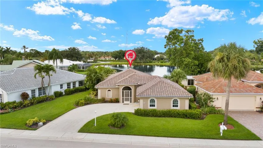 Mediterranean / spanish-style home with a front yard, a water view, and a garage