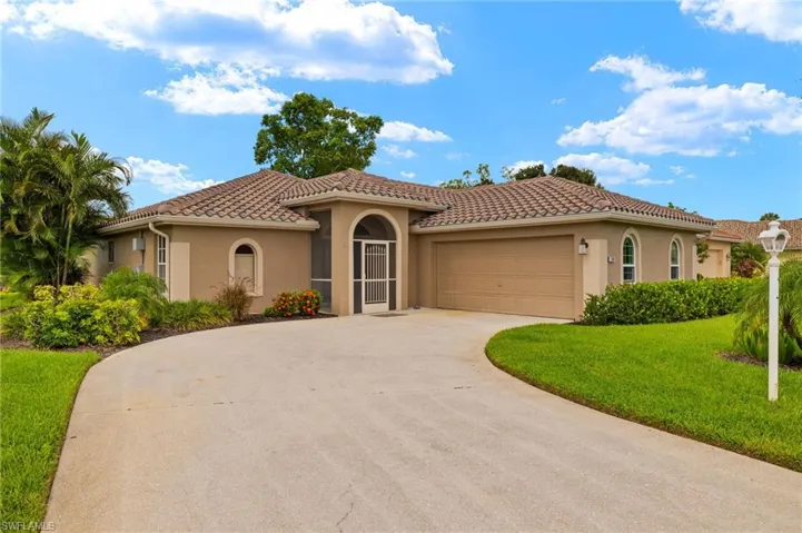 Mediterranean / spanish home with a garage and a front yard