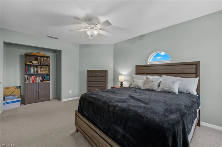 Carpeted bedroom with ceiling fan
