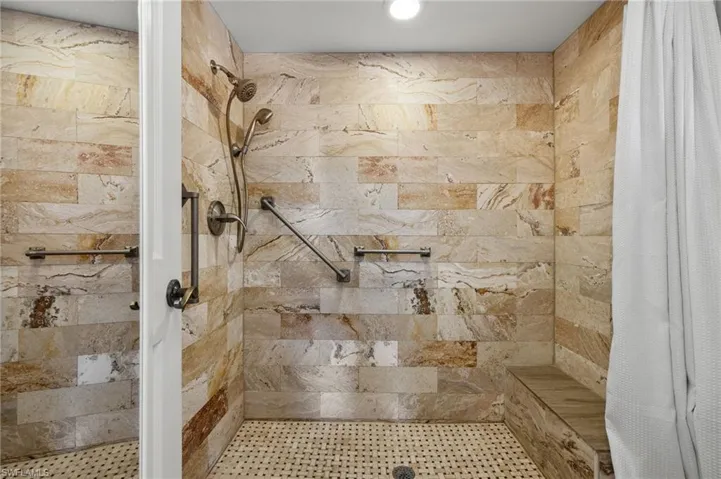 Bathroom featuring curtained shower