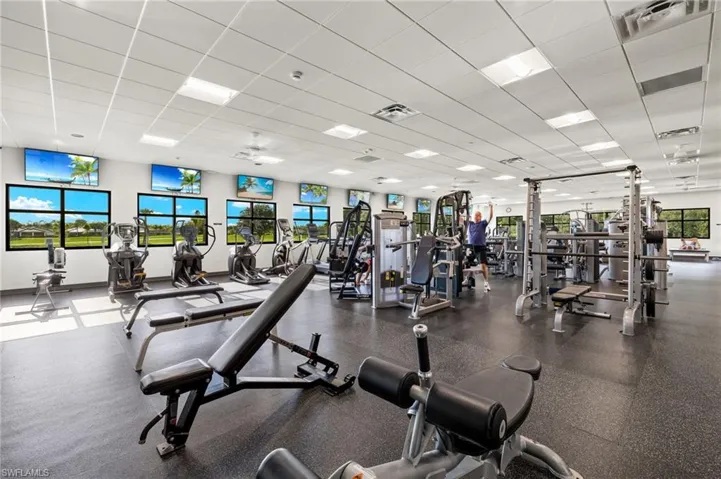 Gym with a wealth of natural light and a paneled ceiling
