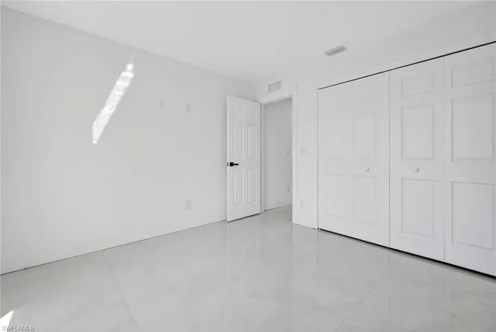 Unfurnished bedroom with light tile patterned floors and a closet