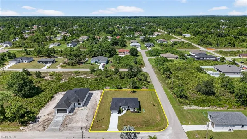 Aerial view of residential area featuring property boundaries highlighted