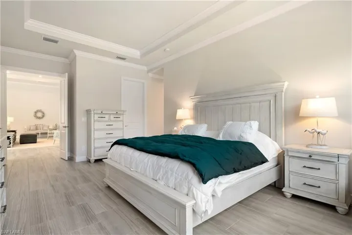Bedroom featuring wood finish floors and a raised ceiling