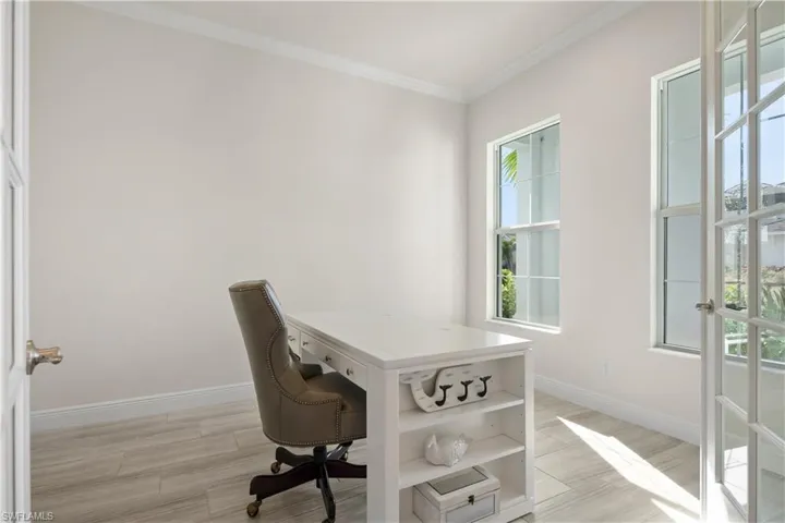 Office with ornamental molding and wood finish floors