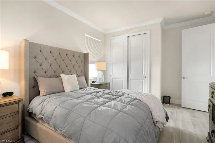 Bedroom with a closet and ornamental molding
