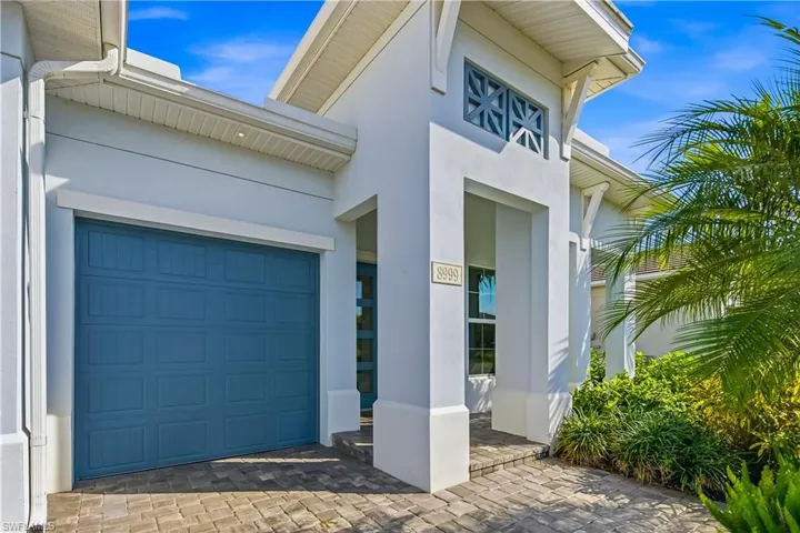 View of exterior entry with stucco siding and an attached garage