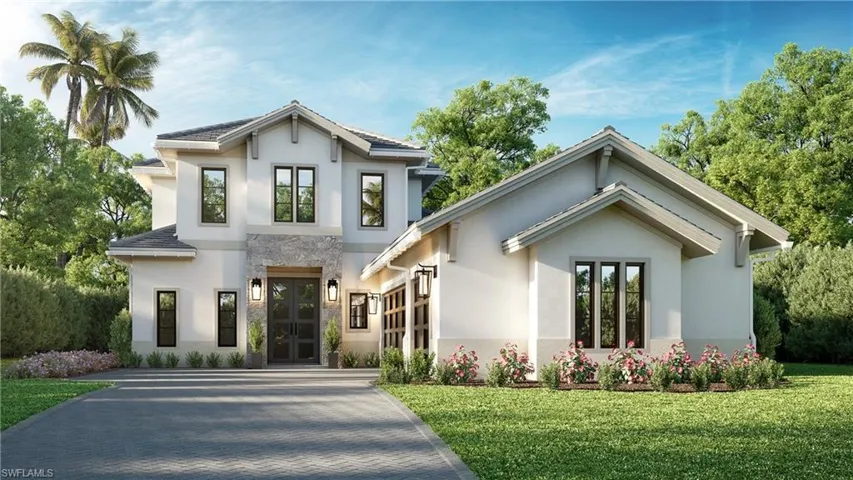 View of front of house with decorative driveway, stucco siding, and a front yard