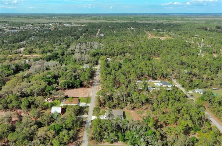 View of property location featuring a forest