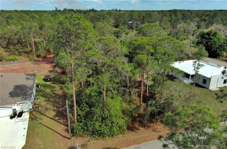 View from above of property with a forest