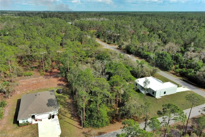 View from above of property featuring a heavily wooded area