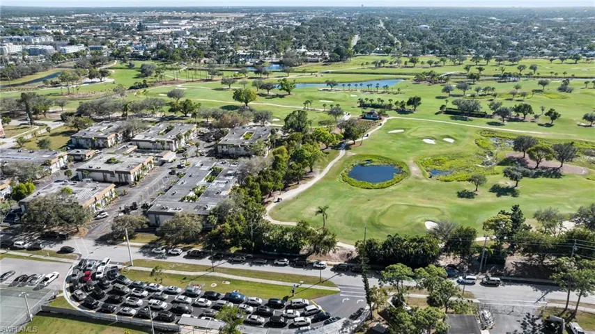 Birds eye view of property with a water view