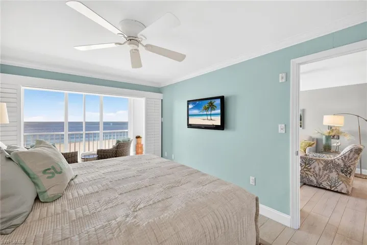 Bedroom featuring crown molding, wood finished floors, and ceiling fan
