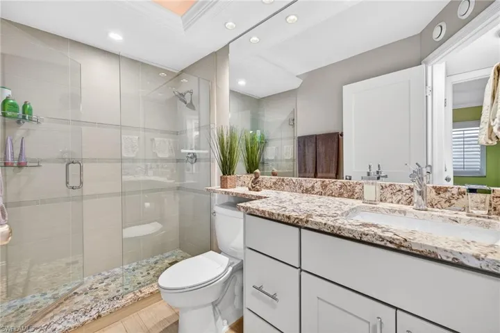 Full bath featuring a shower stall, vanity, and recessed lighting