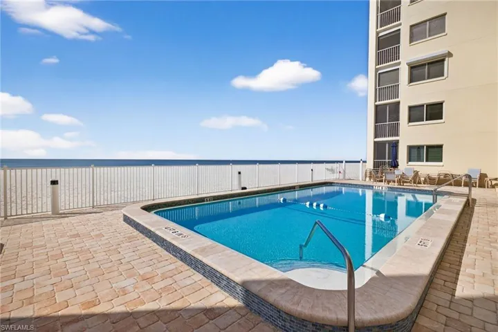 Community pool featuring a patio and a water view