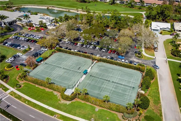 Drone / aerial view of a nearby body of water and a golf course